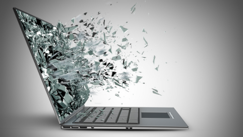 A laptop with shards of the screen exploding outwards