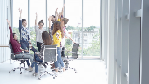 A diverse team excited in an office