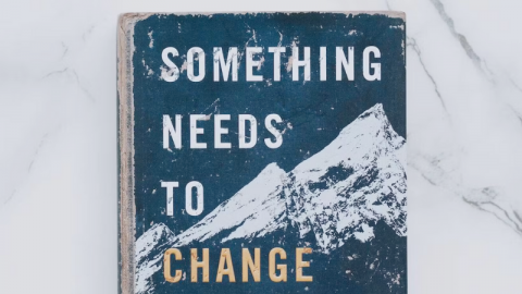 A ragged book with the cover titled Something Needs to Change