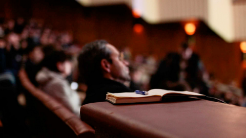 A blurry image of a large full lecture hall