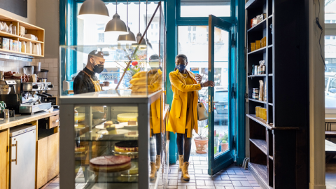 People wearing medical face masks in a cafe