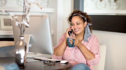 A woman talking on a phone in a modern and elegant room