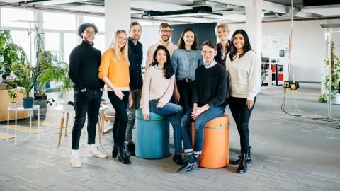 A group of young workers in a modern office environment